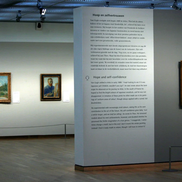 Visitors admiring Vincent van Gogh's masterpieces inside the spacious, daylight-filled Rietveld building galleries at the Van Gogh Museum